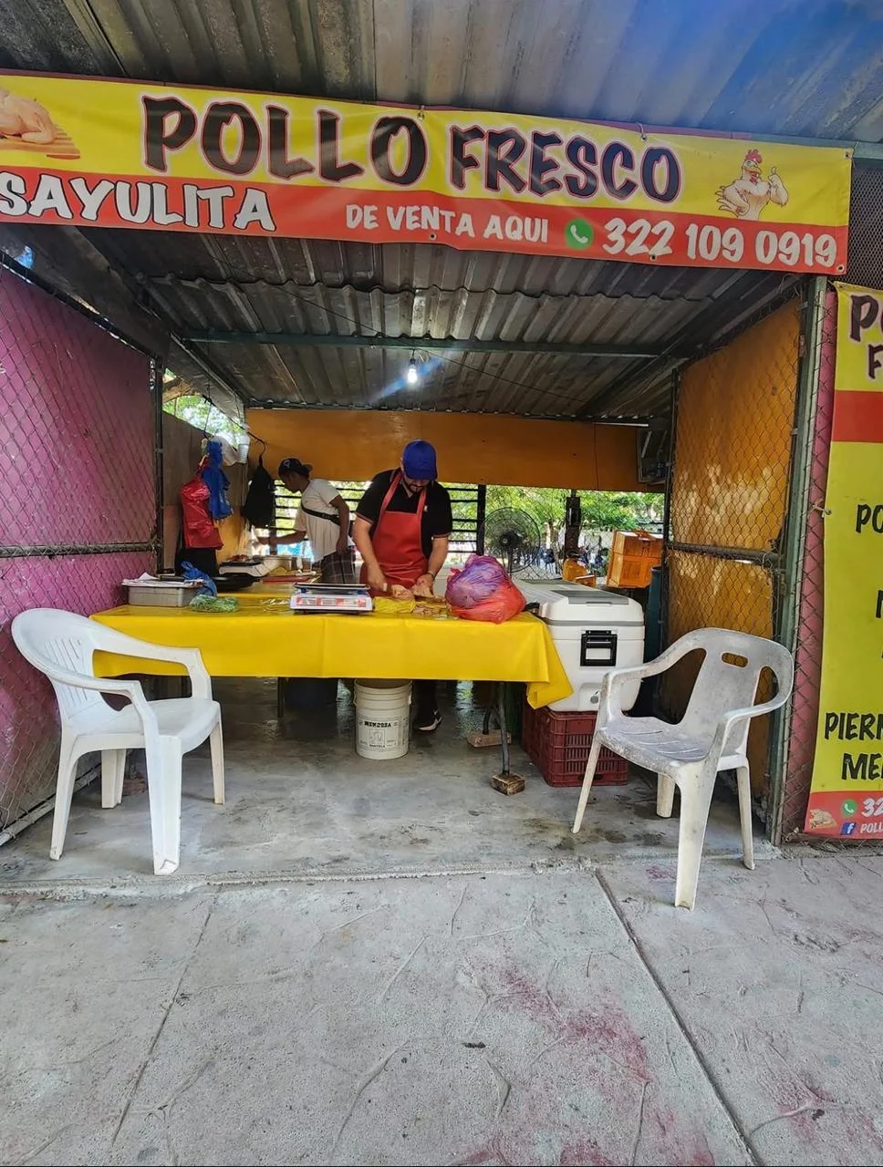 Local de Pollo Fresco Sayulita con el equipo preparando cortes en el mostrador.